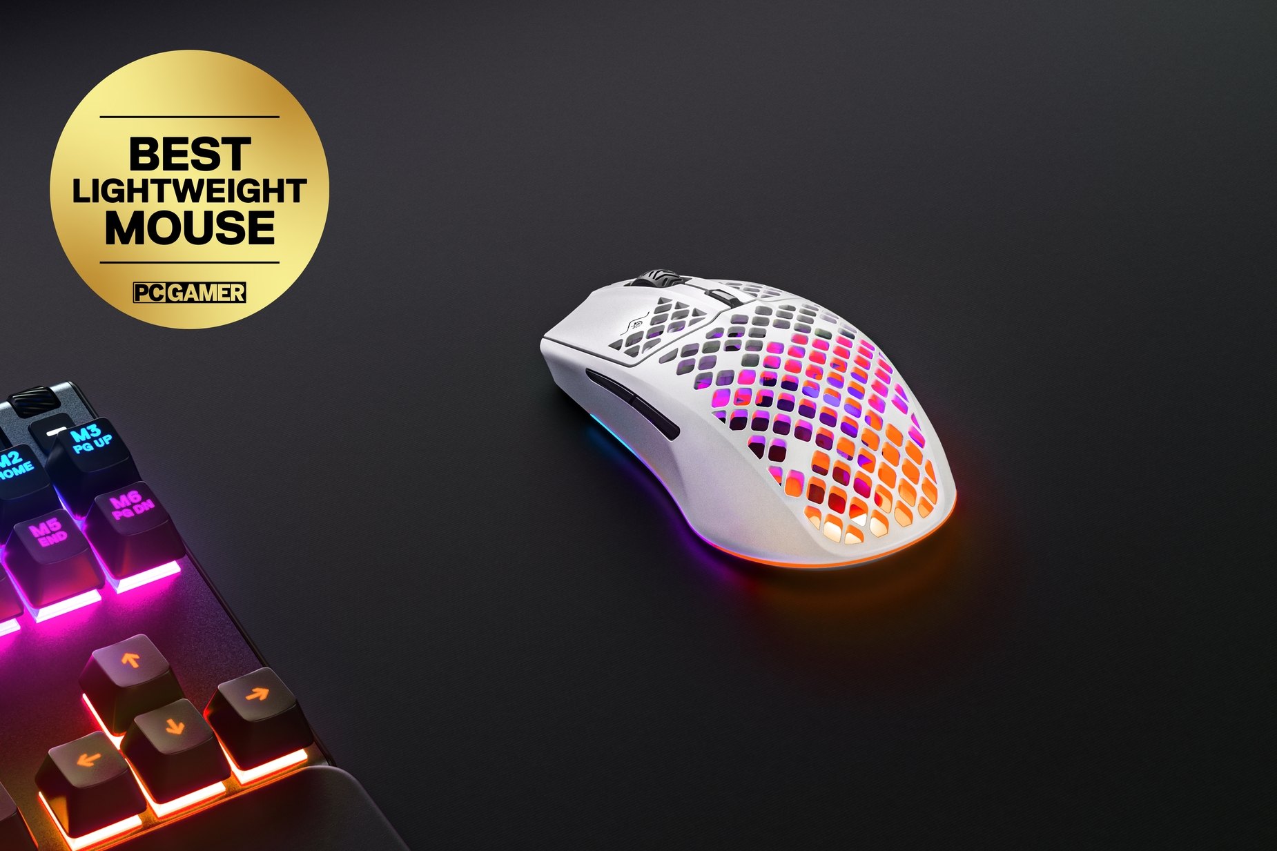 
 White Aerox 3 Wireless (2022), sitting next to a SteelSeries keyboard. Award sticker reads, "Best Lightweight Mouse: PC Gamer."
 