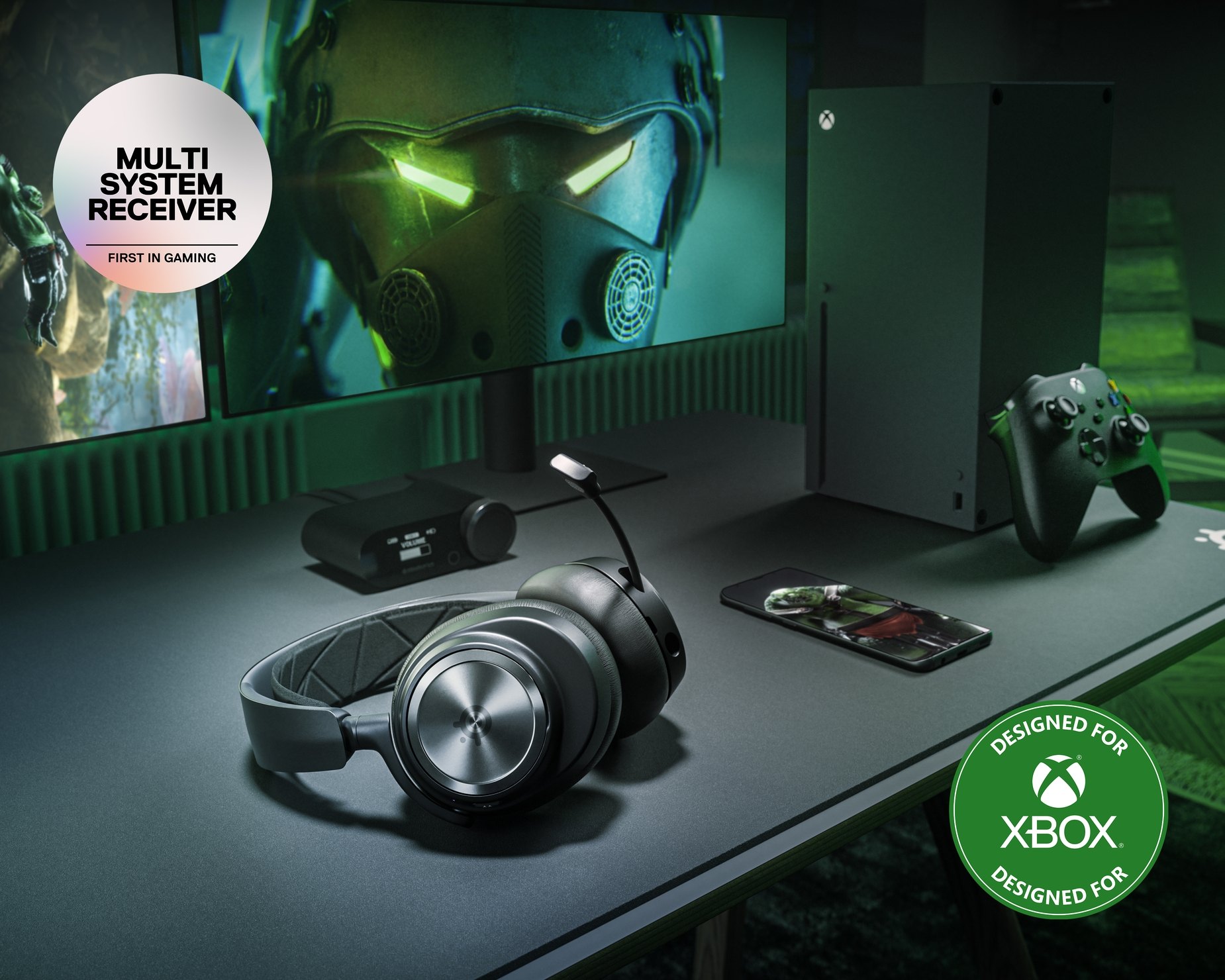 
 An Arctis Nova Pro Wireless and base station lays against a desktop setup. A badge with text reads: "Multi-System Receiver, First in Gaming." A second badge with text reads: "Designed for Xbox."
 