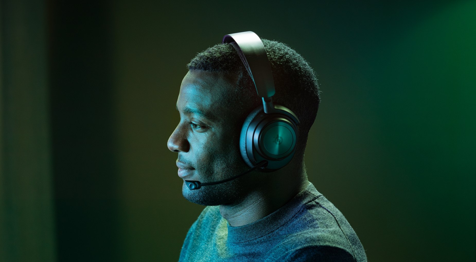 
 A person wears an Arctis Nova Wireless headset while playing a game.
 