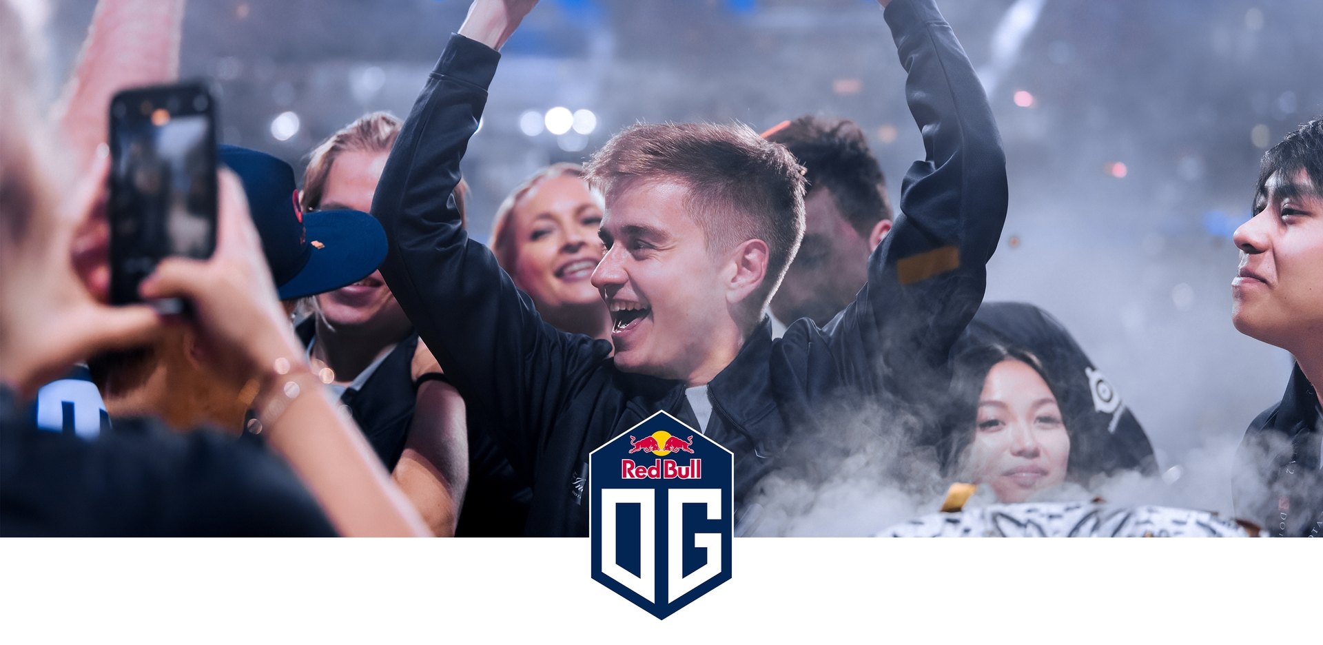 Team OG logo with them celebrating at a tournament