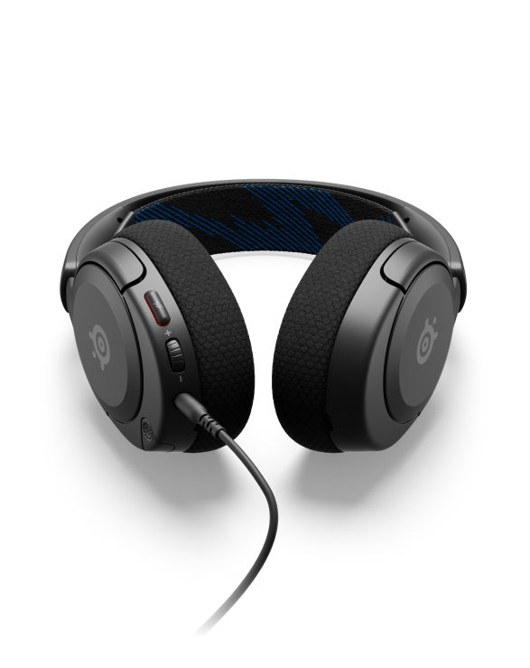 
 An Arctis Nova headset laying on a surface with the controls visible.
 