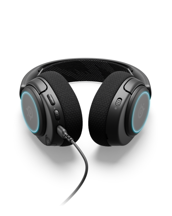 
 An Arctis Nova 3 headset laying on a surface with the controls visible.
 