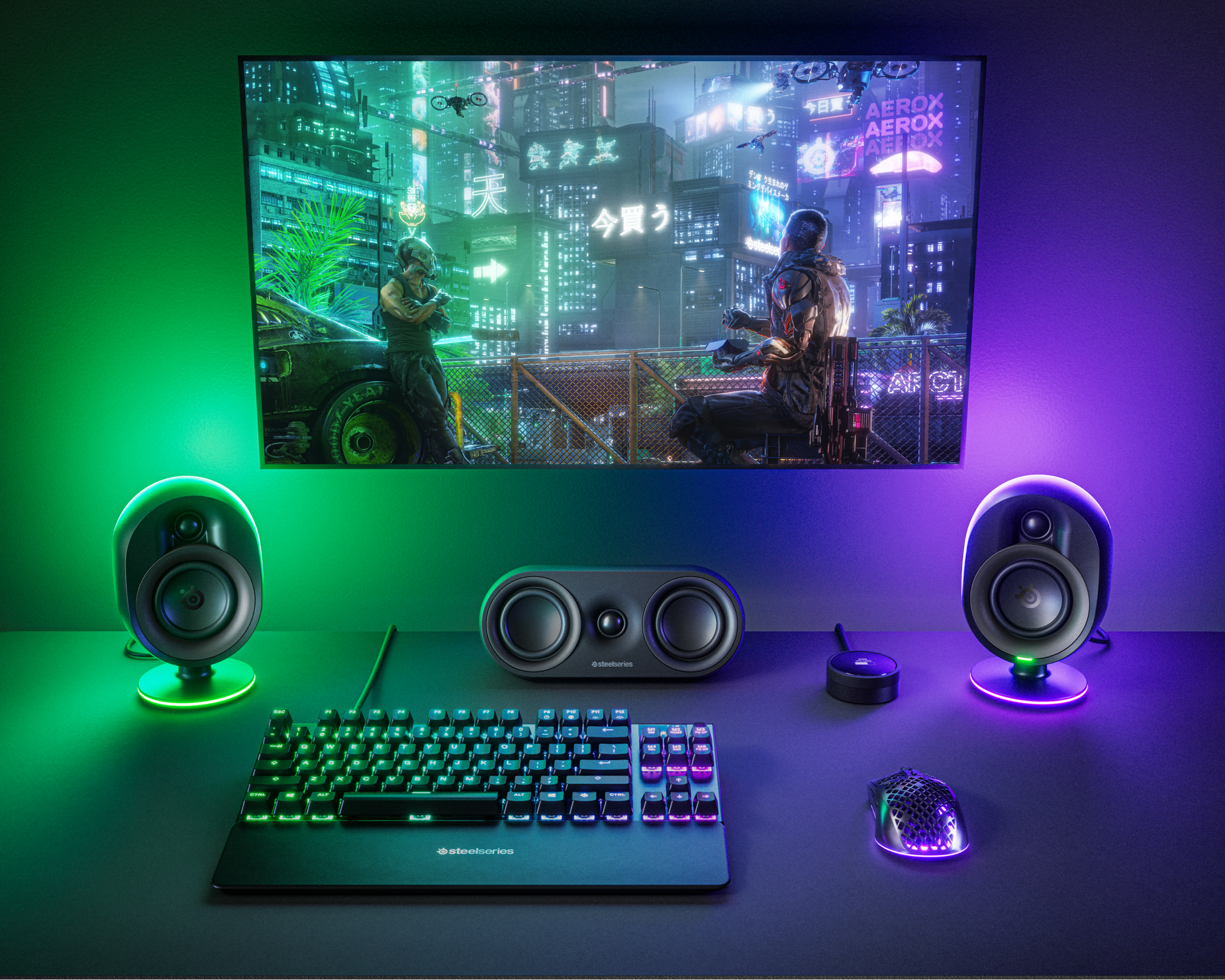 
 A desktop setup complete with a keyboard, mouse, and Arena 9 speakers lit up in moody green and purple RGB lighting.
 
